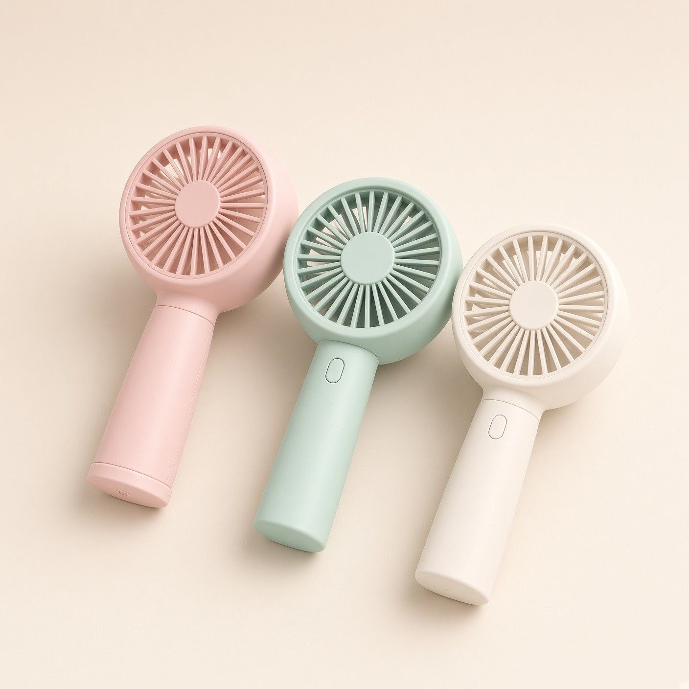 분홍·민트·흰색 손풍기 세 개를 나란히 눕혀 둔 모습